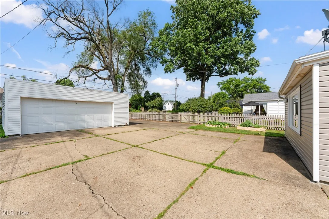 View of patio with an outbuilding and a garage
