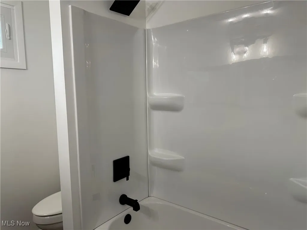 Bathroom with toilet and  shower combination
