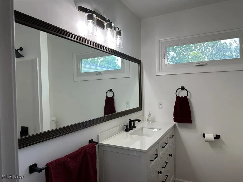 Bathroom featuring plenty of natural light and vanity