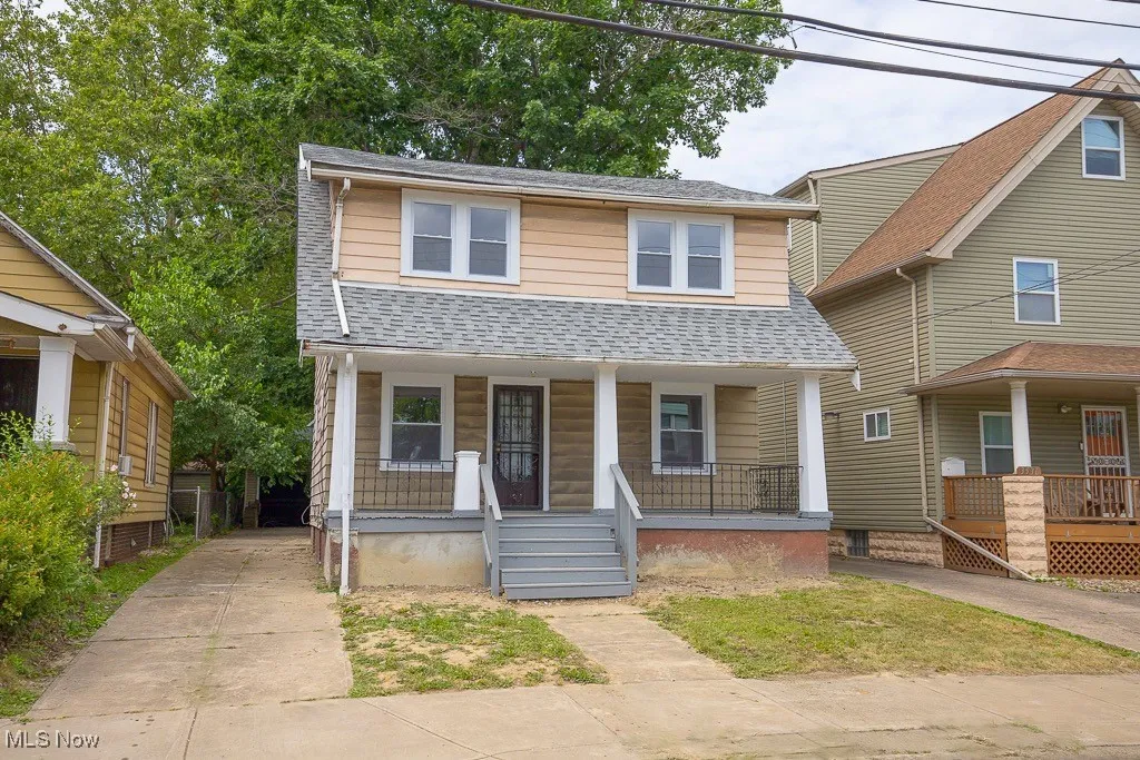 View of front of home featuring a porch and a shingled roof