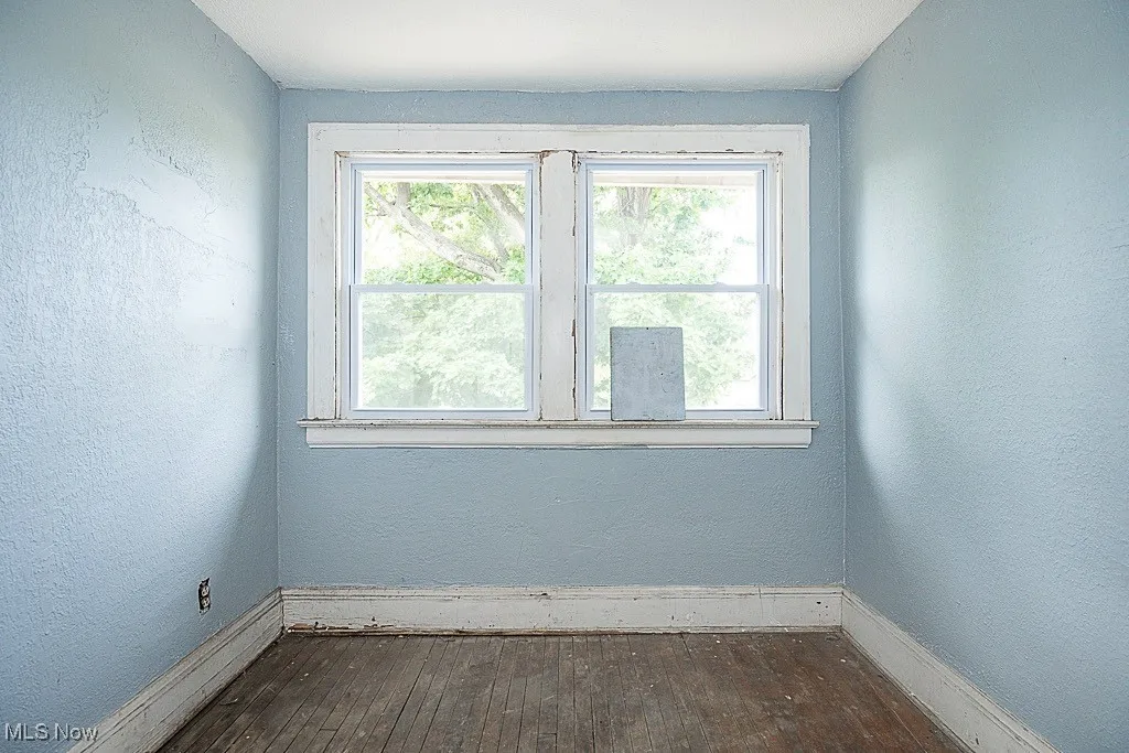 Spare room featuring wood-type flooring