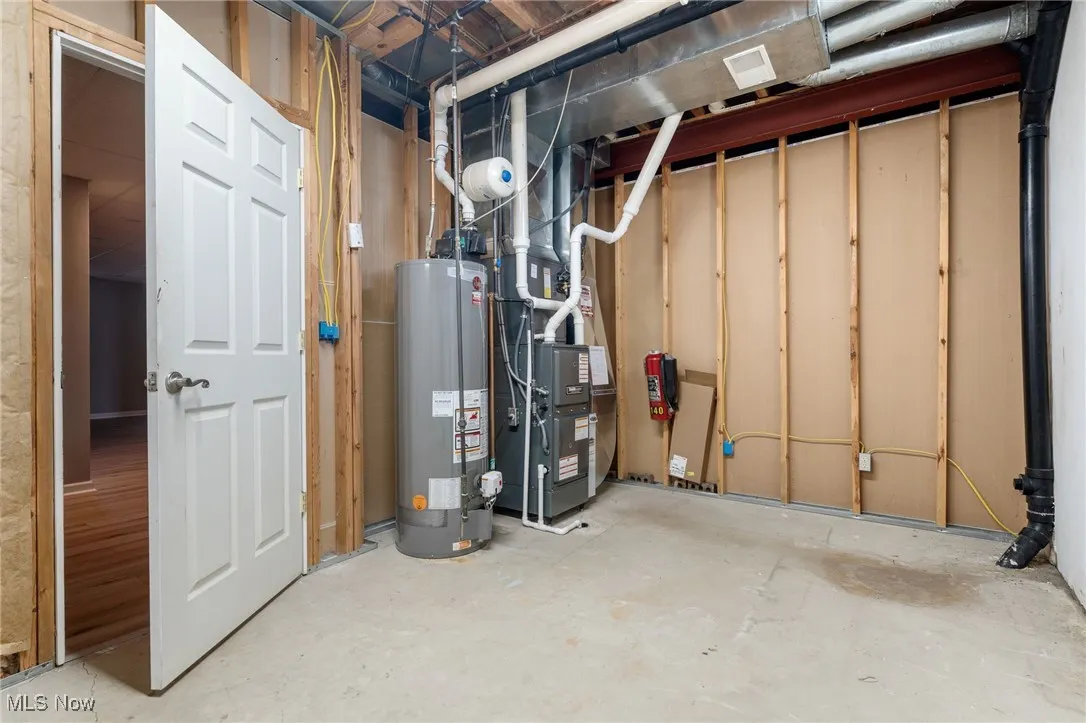 Unfinished basement with gas water heater and heating unit