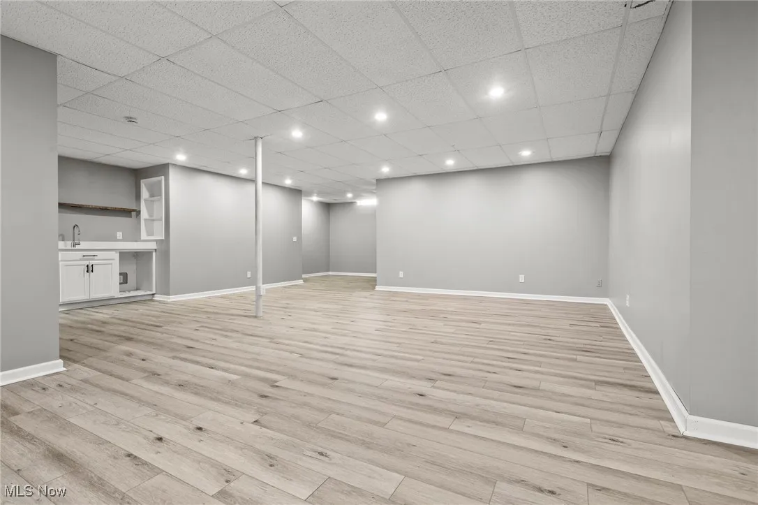 Finished basement featuring light wood-style flooring and recessed lighting