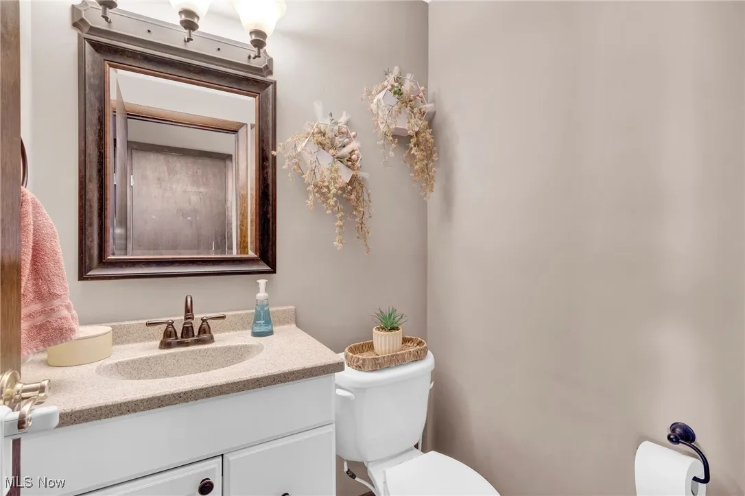 Half bathroom featuring toilet and vanity