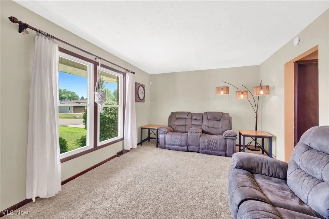 Carpeted living area with baseboards