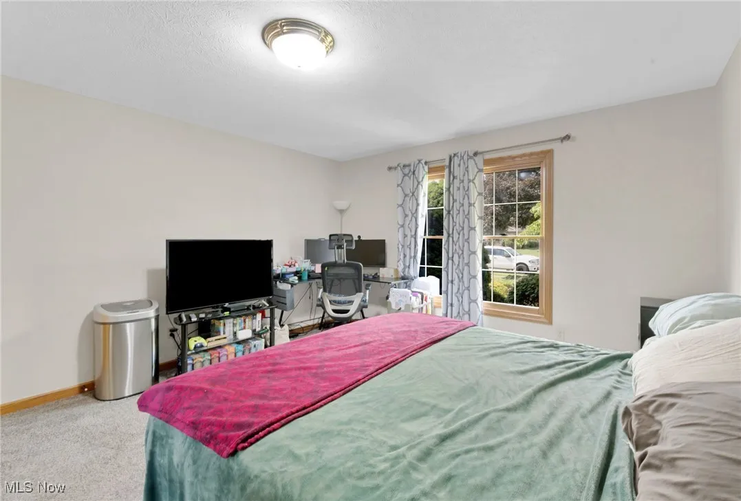 Carpeted bedroom with baseboards
