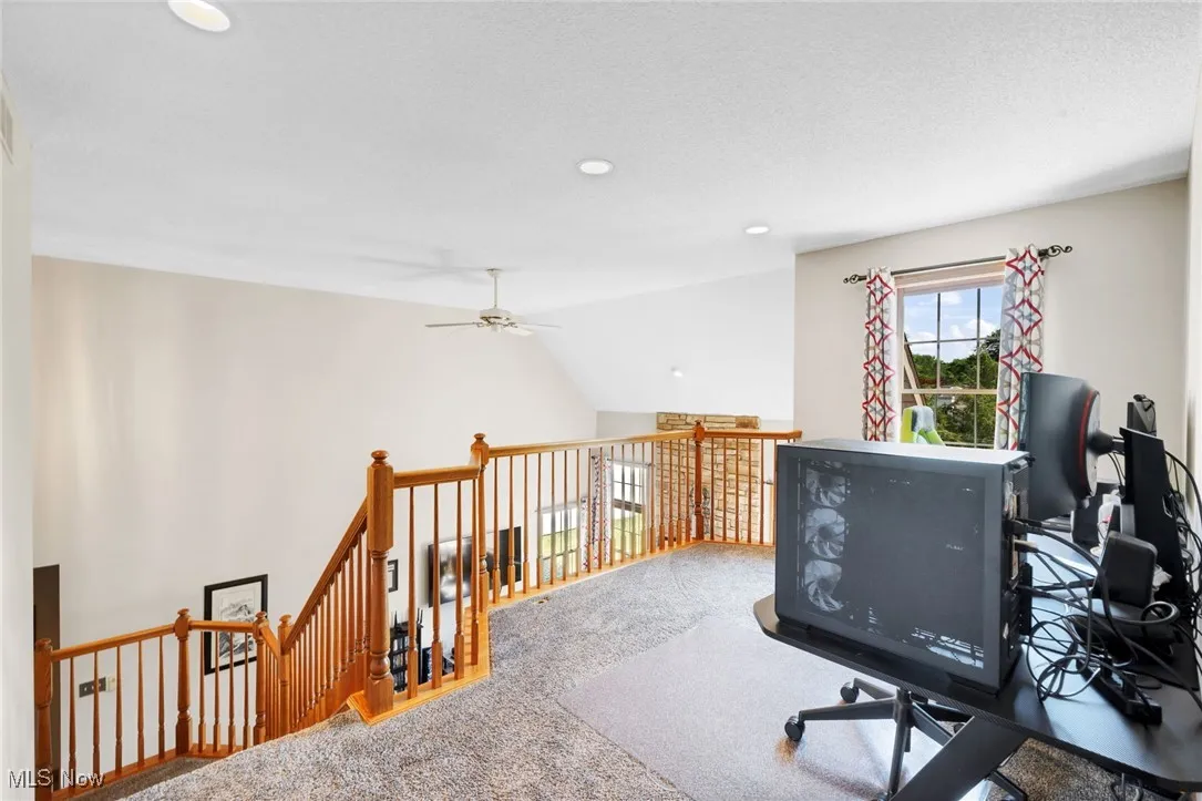 Carpeted office with ceiling fan, recessed lighting, and vaulted ceiling