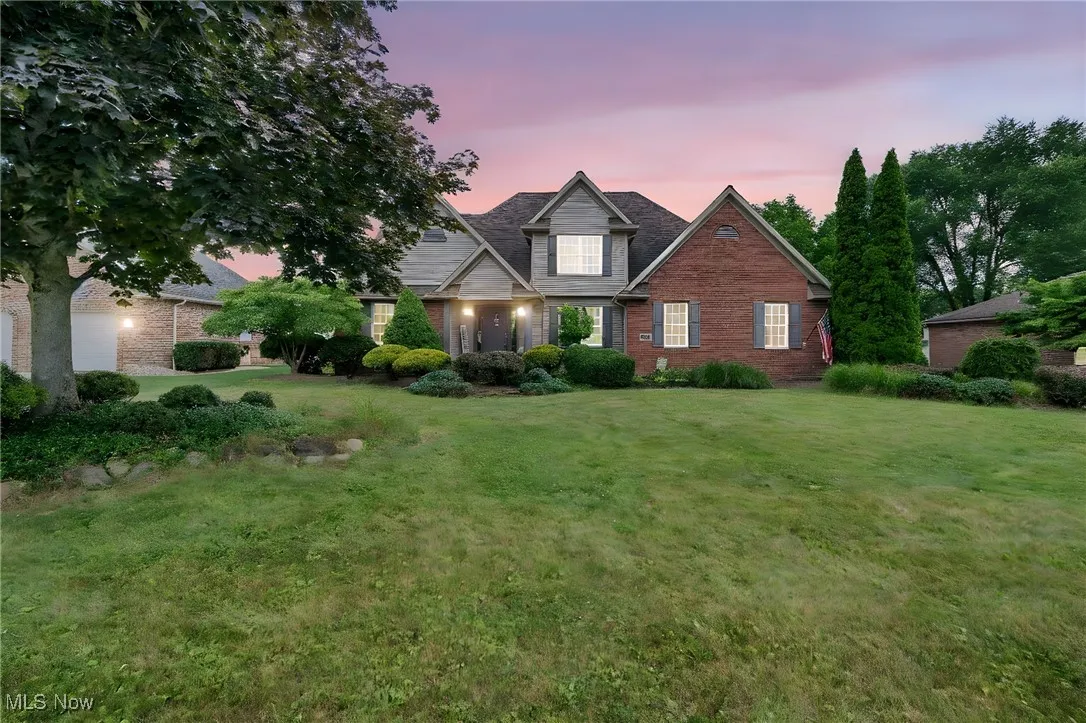 Traditional-style house with brick siding and a yard