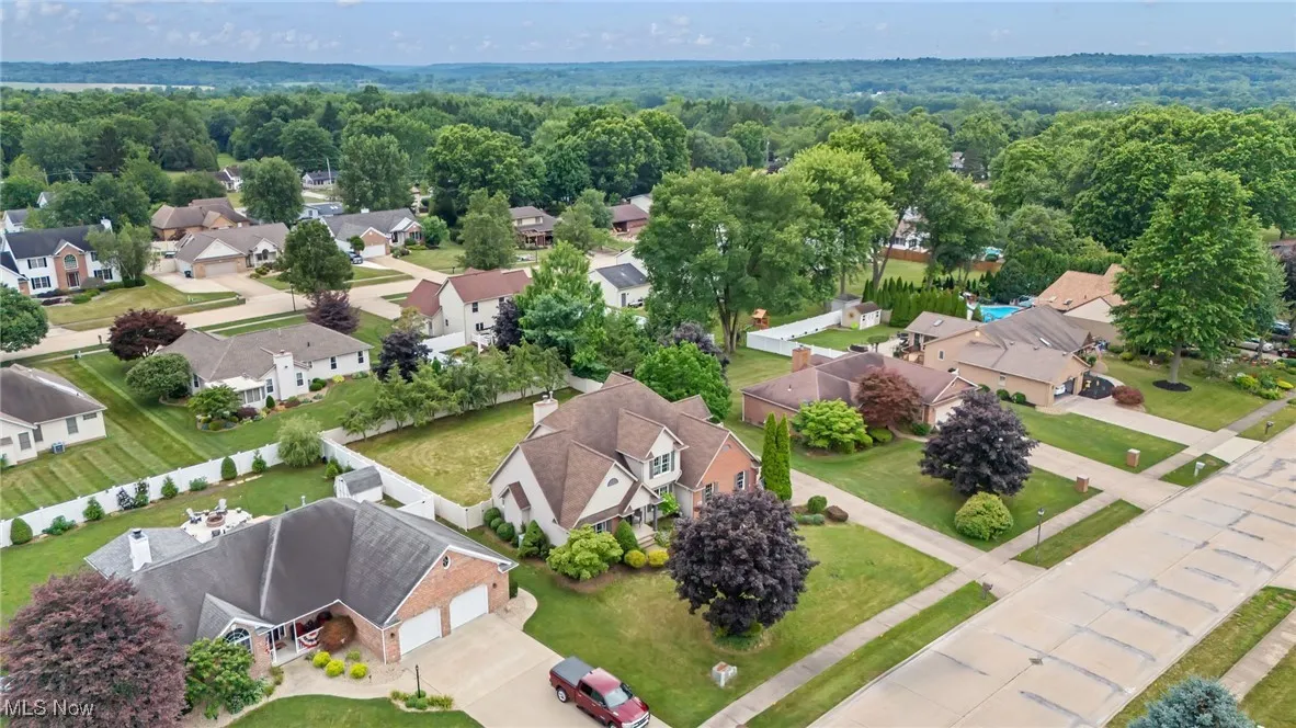 Aerial perspective of suburban area with a heavily wooded area