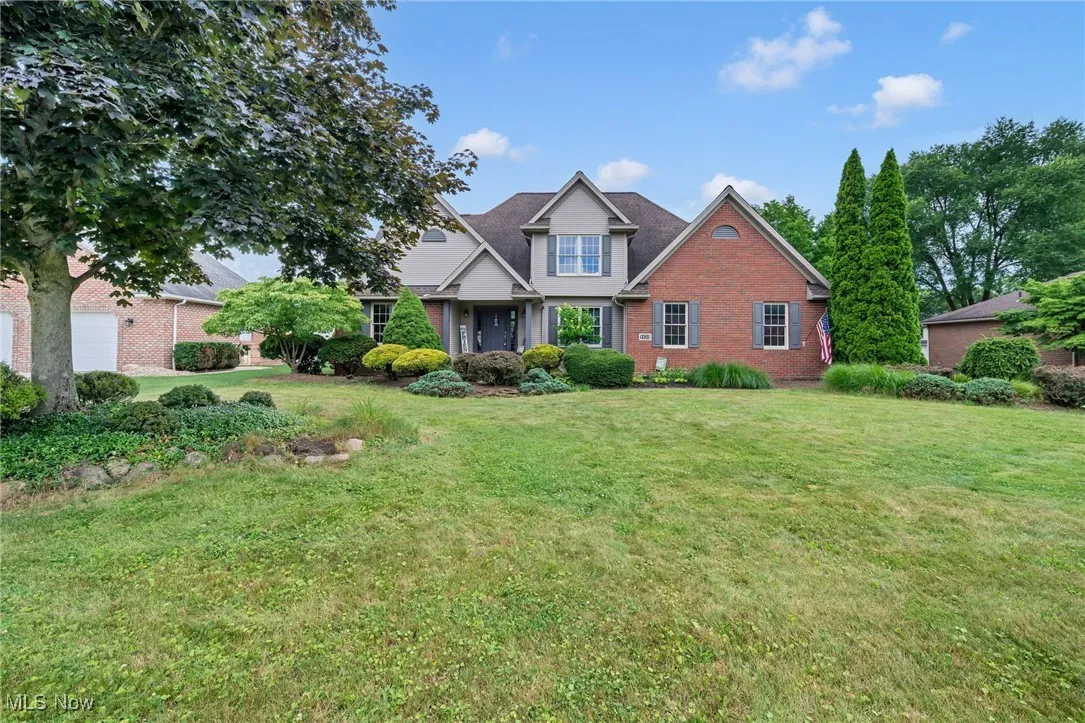 View of front of house with brick siding and a front yard