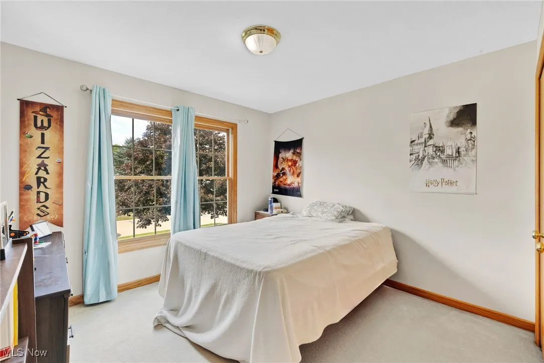 Bedroom featuring light colored carpet