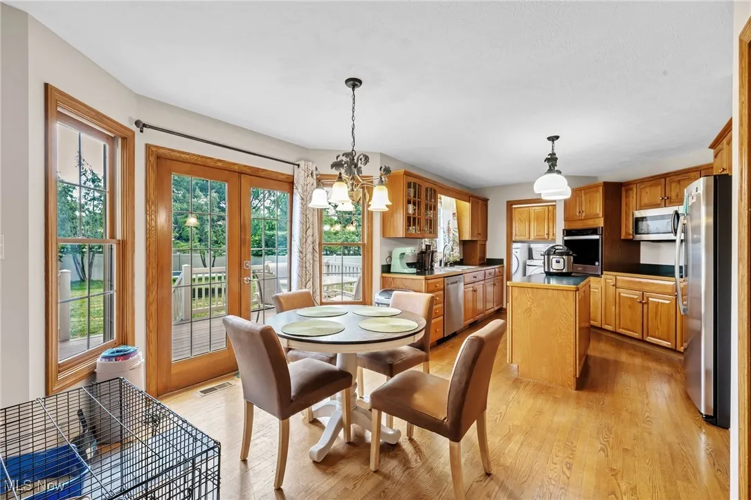 Dining room featuring a chandelier, light wood-type flooring, and washer / clothes dryer