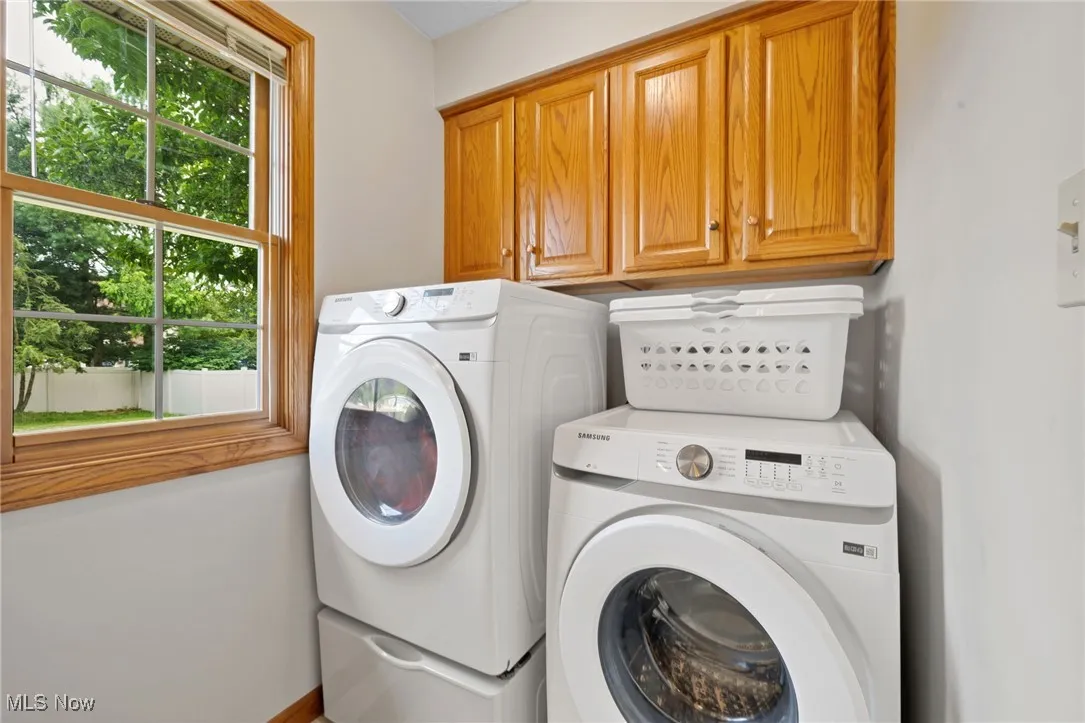 Laundry room featuring cabinet space and washing machine and clothes dryer