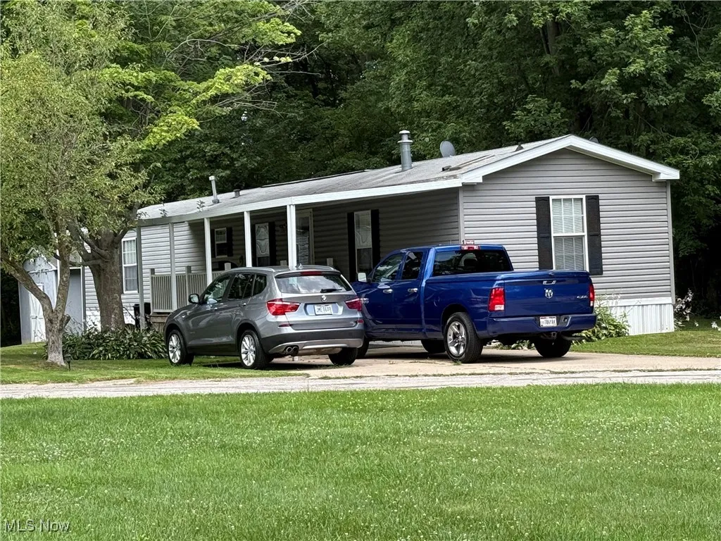 View of car parking featuring a carport and driveway