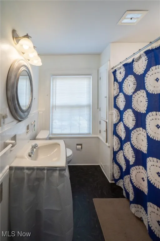 Full bath featuring vanity and a shower with curtain