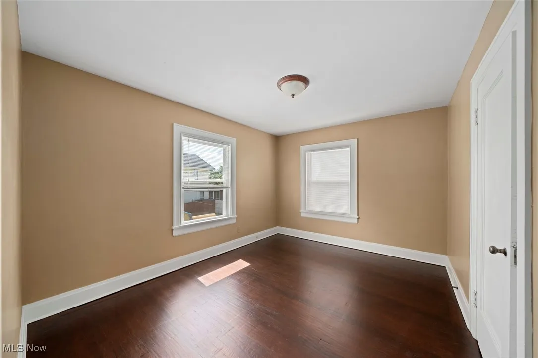 Unfurnished room with dark wood-style floors