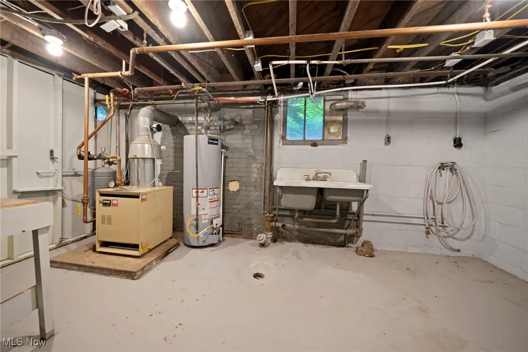 Below grade area featuring gas water heater and a heating unit