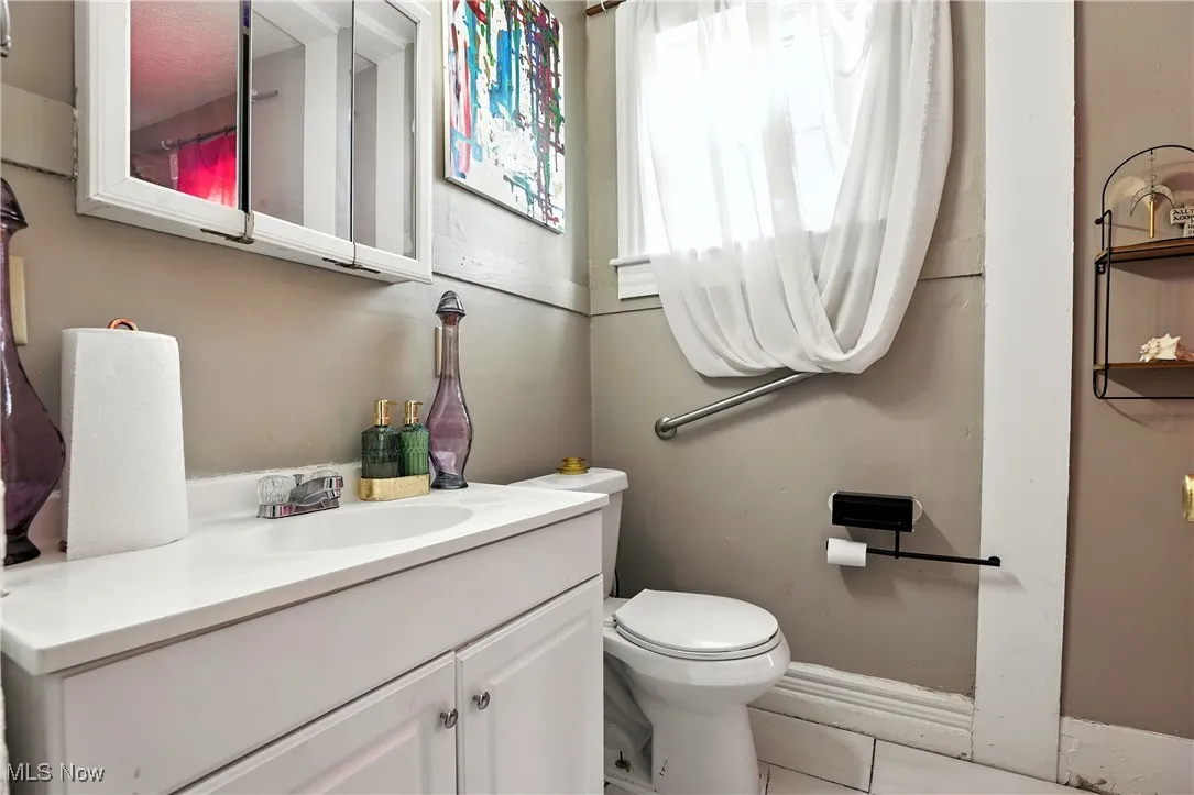 Half bath featuring vanity and tile patterned flooring