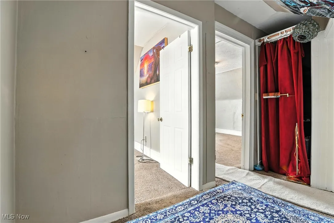 Hall with carpet floors and baseboards