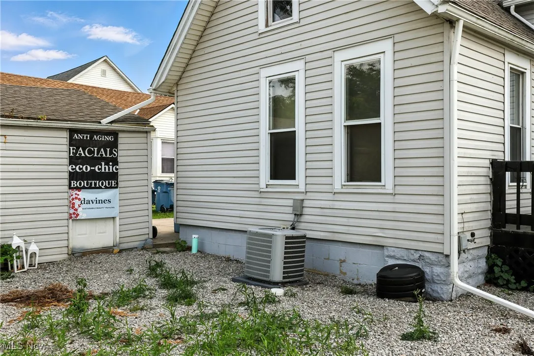 View of home's exterior with a central AC unit