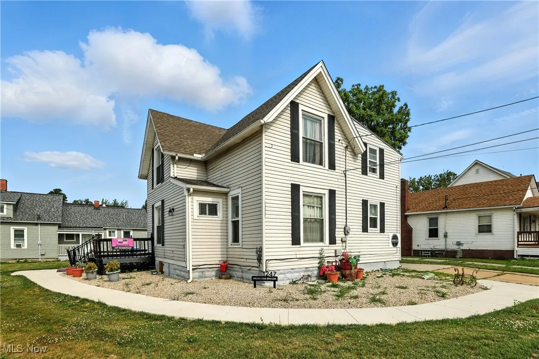 View of property exterior featuring a lawn