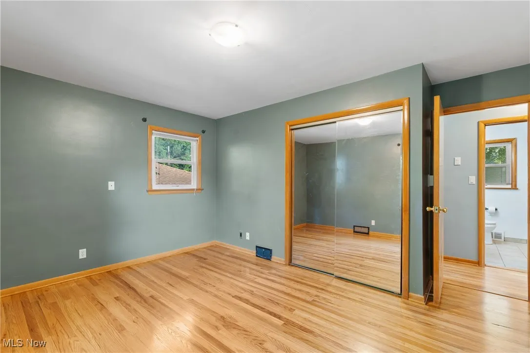 Unfurnished bedroom featuring wood finished floors and a closet