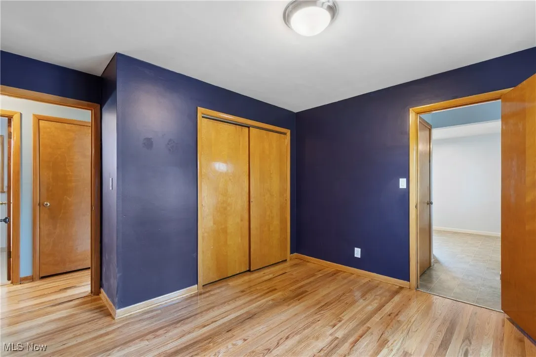 Unfurnished bedroom with a closet and wood finished floors