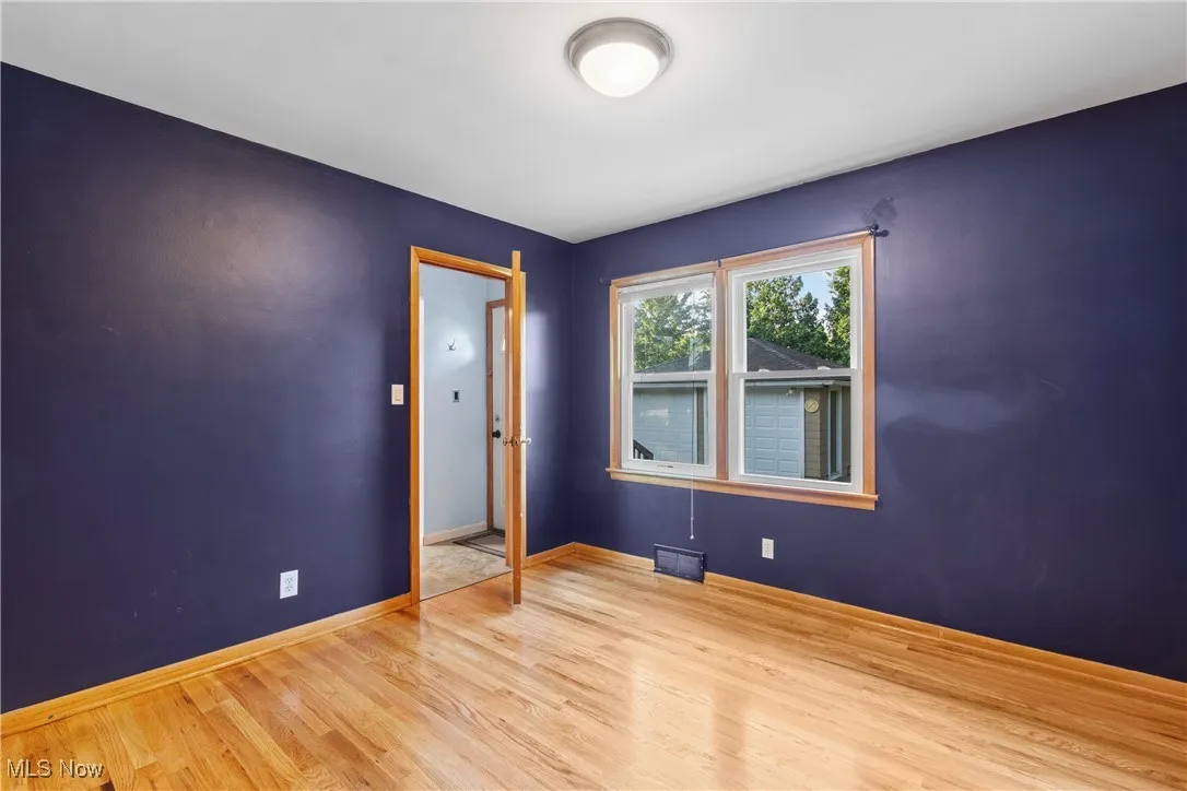 Spare room featuring wood finished floors and baseboards