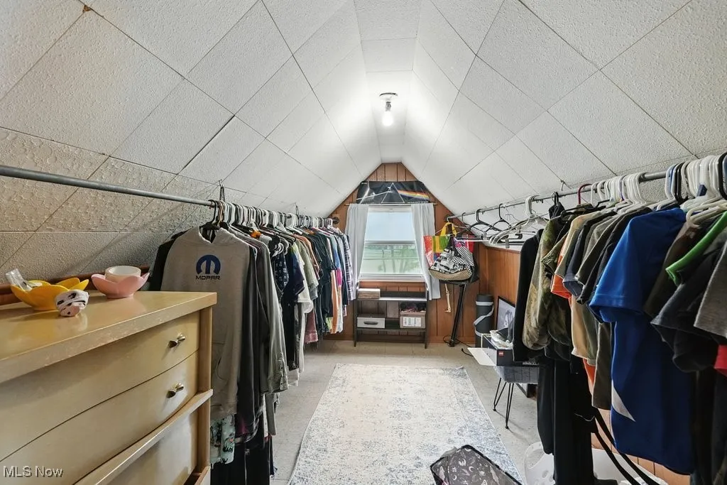 Spacious closet featuring vaulted ceiling