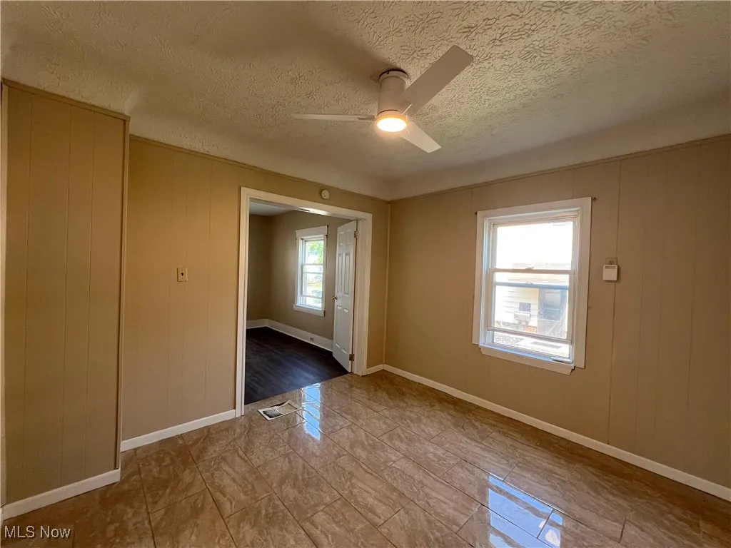 Spare room with ceiling fan and a textured ceiling
