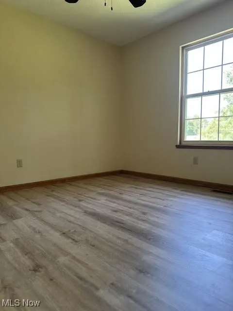 Bedroom 2 room with Laminated  wood finished floors and a ceiling fan