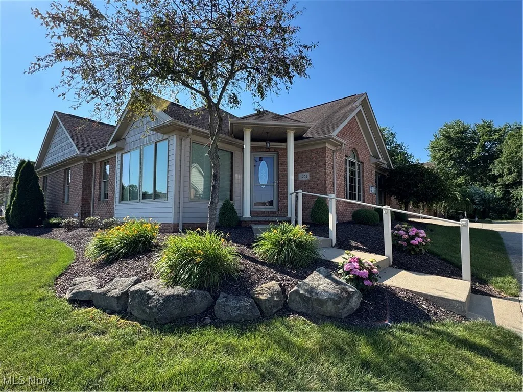 Ranch-style home featuring brick siding and a front lawn