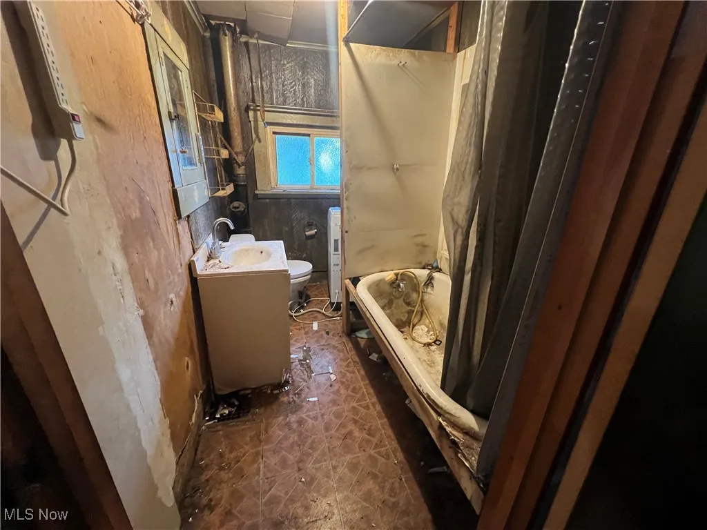 Full bath featuring vanity and shower / tub combo