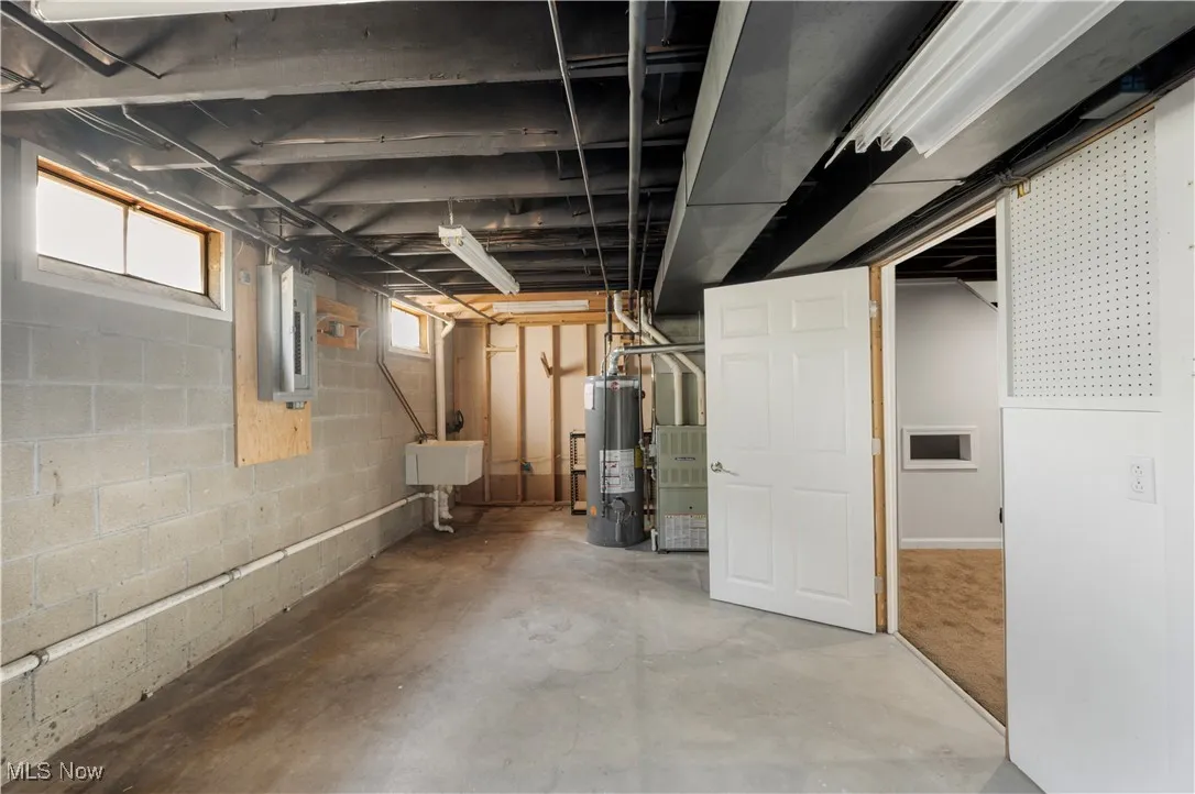 Below grade area with gas water heater and electric panel