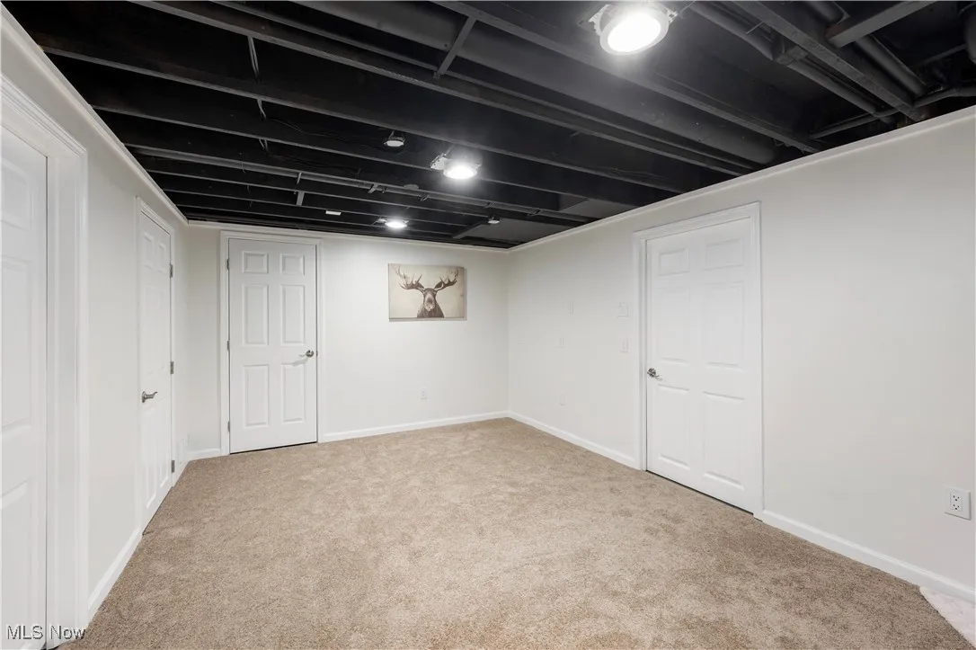 Finished basement with carpet floors and baseboards