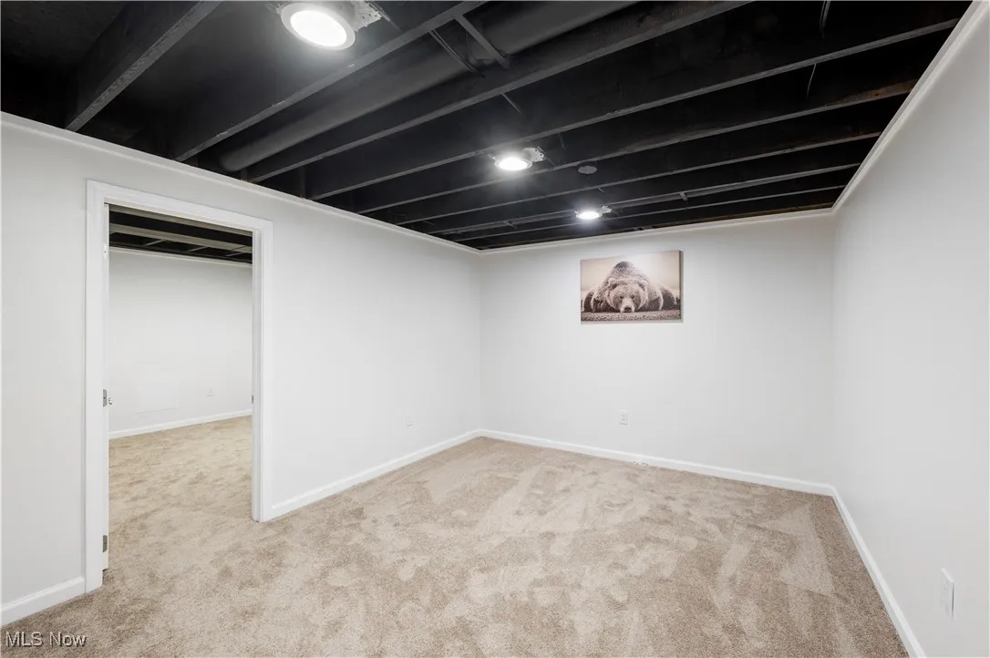 Finished below grade area featuring carpet floors and baseboards