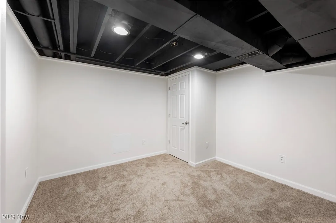 Finished below grade area featuring carpet and baseboards