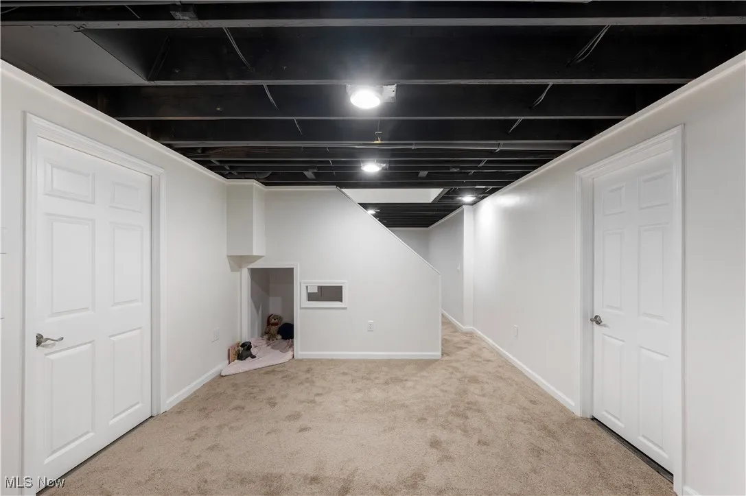Finished below grade area with carpet flooring and baseboards