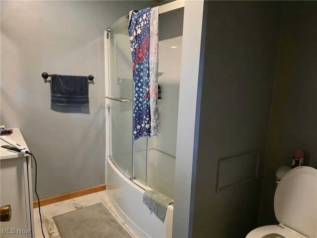 Bedroom with dark wood-type flooring, ornamental molding, and a ceiling fan