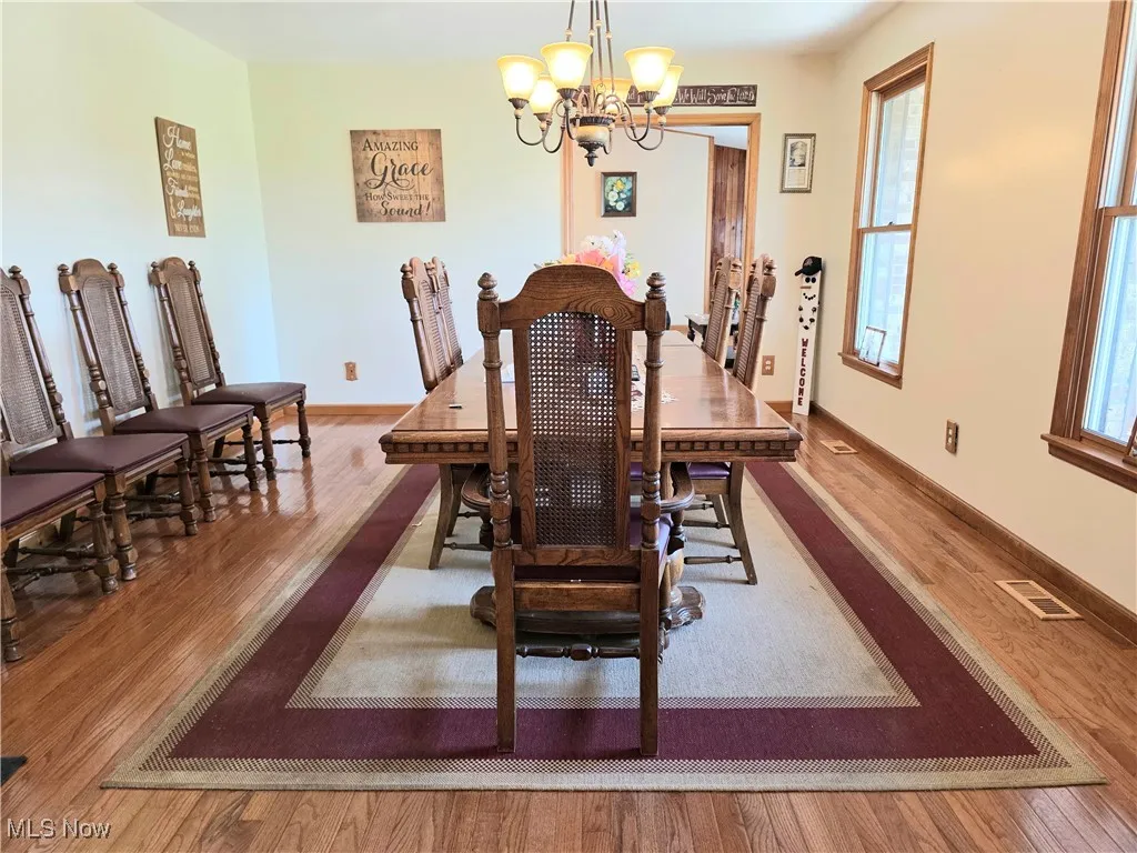 Dining area featuring a chandelier and wood finished floors