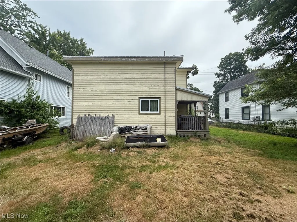Rear view of house with a yard