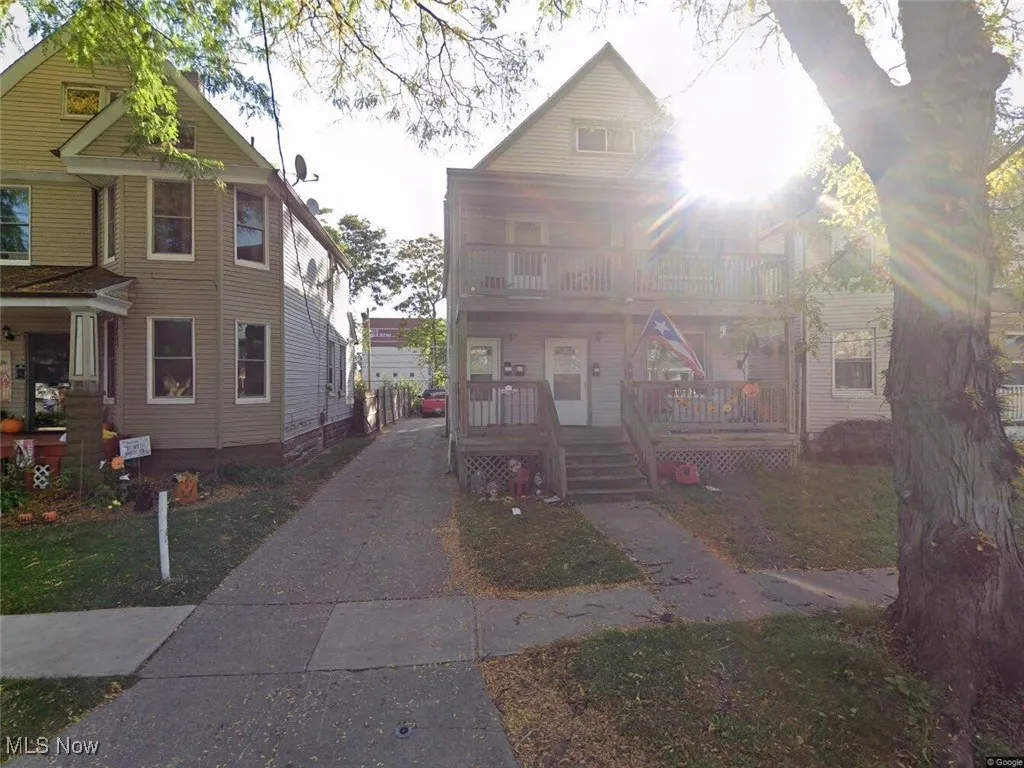 View of front of property featuring covered porch and a balcony