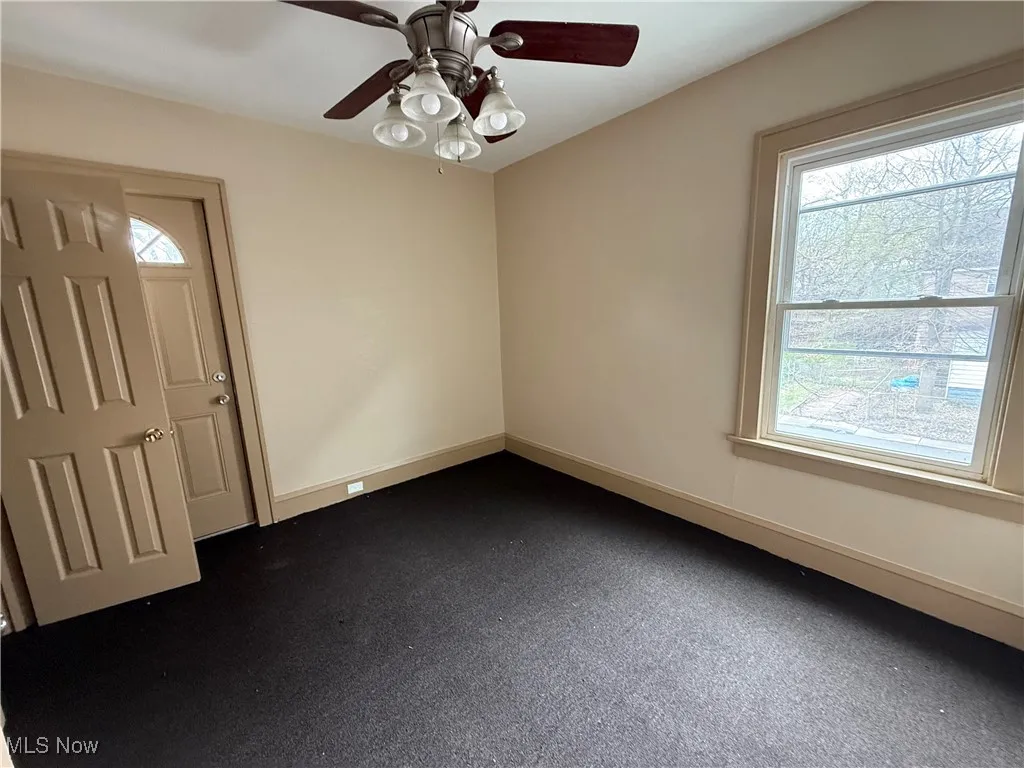 Unfurnished room with plenty of natural light and a ceiling fan