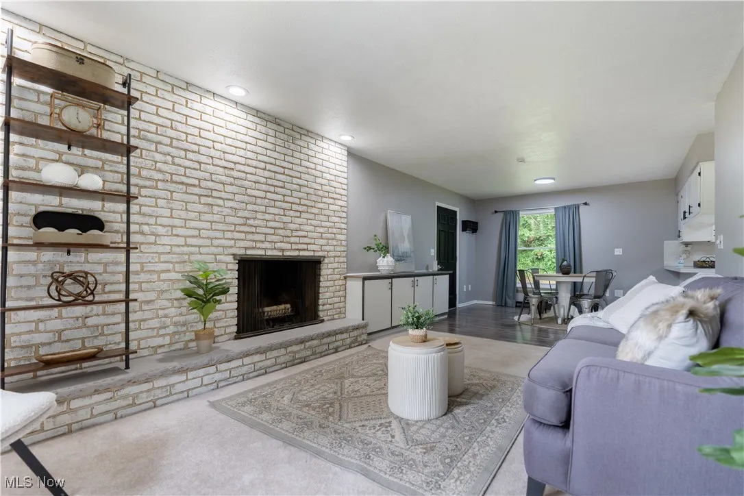 Living area featuring a brick fireplace and recessed lighting