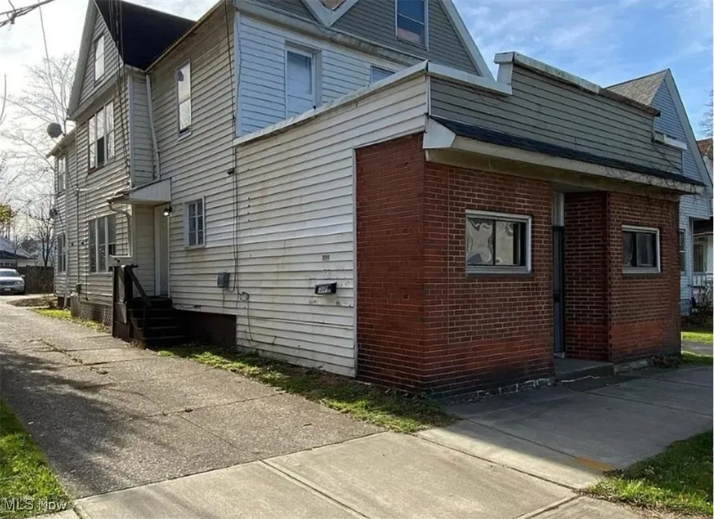 View of home's exterior with brick siding and entry steps