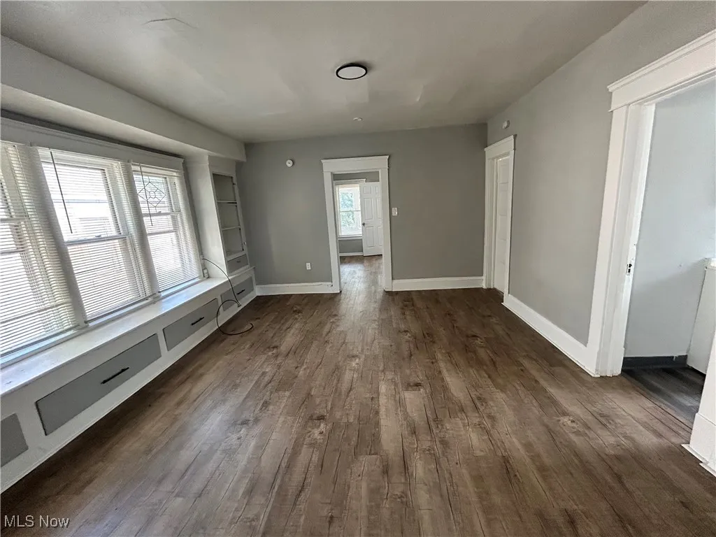 Unfurnished dining area featuring dark wood-style floors