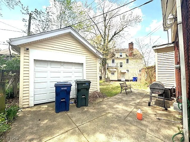 Detached garage featuring concrete driveway