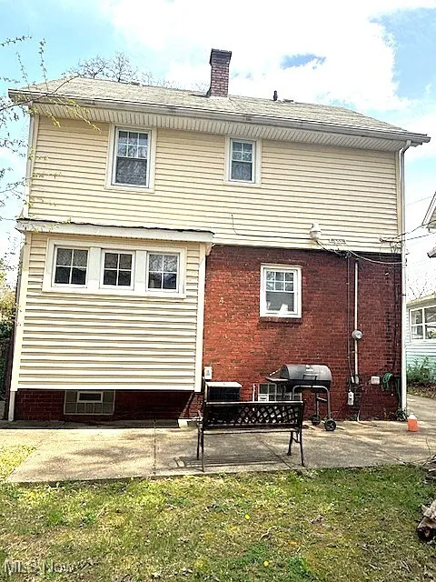 Rear view of property with a patio and a chimney