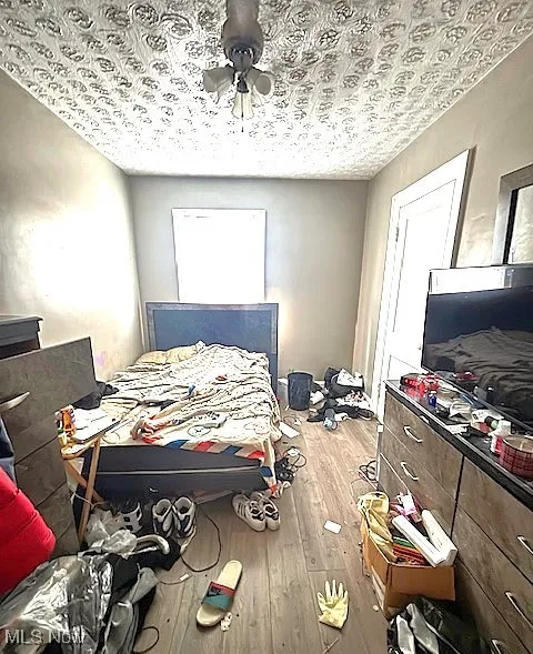 Bedroom with wood-type flooring and ceiling fan
