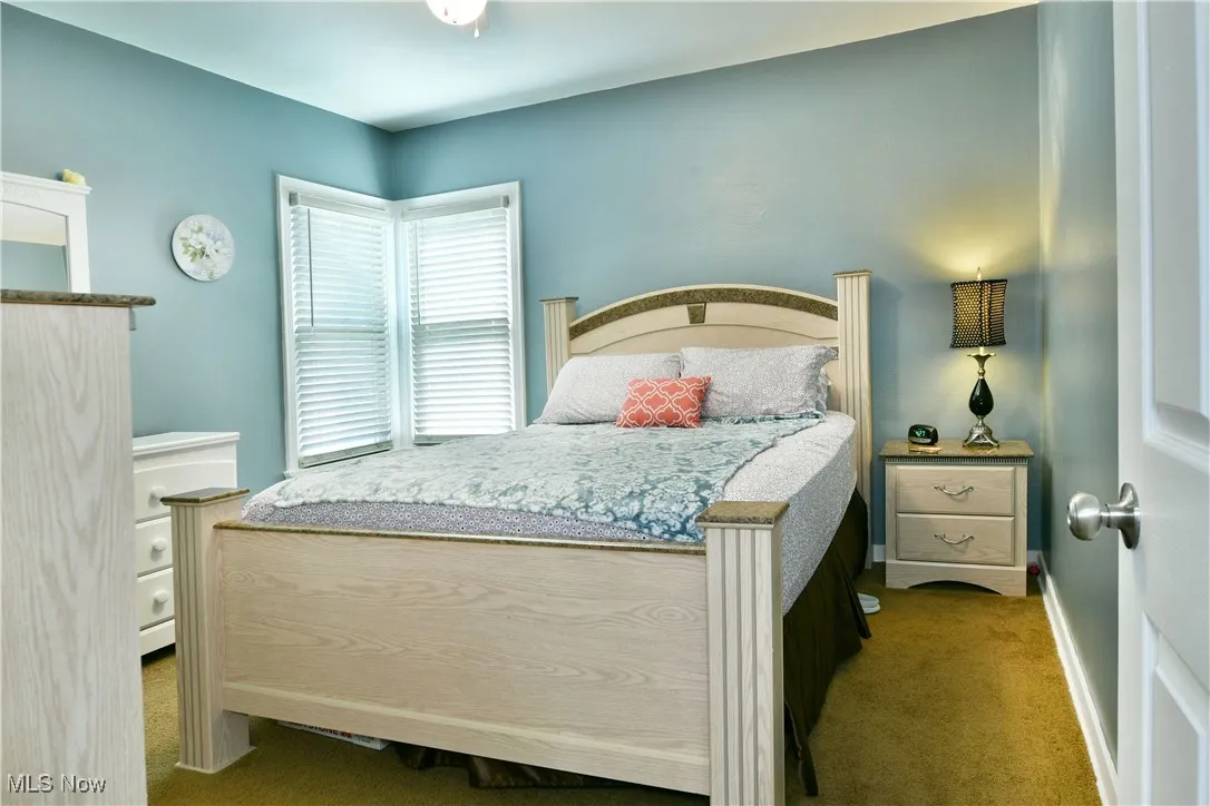 Bedroom featuring carpet flooring and baseboards